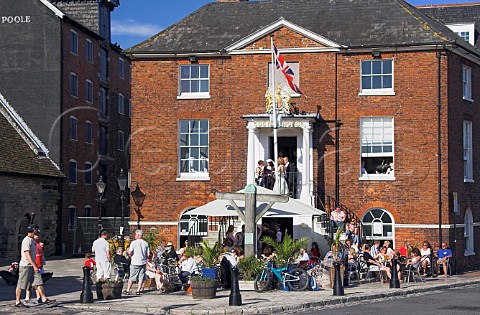 People drinking outside the Old Custom House now   converted into a caf  bar Poole Dorset England