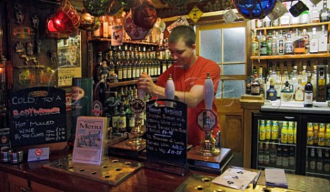 Pulling a pint of Flowers beer in the bar of The Gun   Inn Keyhaven Hampshire England