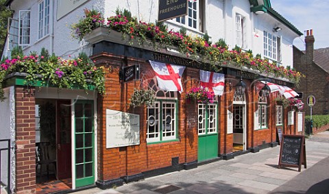 English flags flying outside Worlds End public   house Hampton Middlesex England