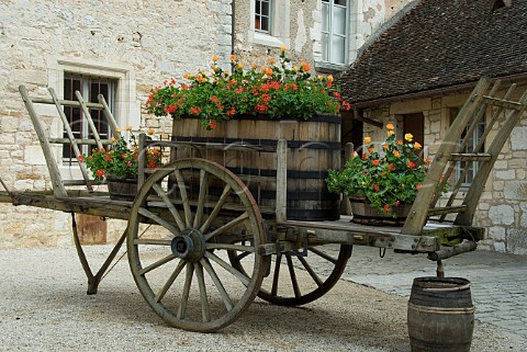 Wooden cart and barrel now used for spring flower   display in the courtyard of Chteau Clos de Vougeot   Cte dOr France