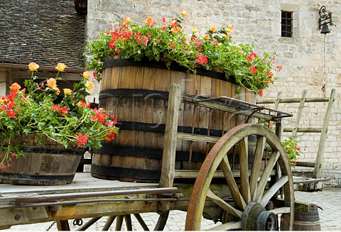 Wooden cart and barrel now used for spring flower   display in the courtyard of Chteau Clos de Vougeot   Cte dOr France