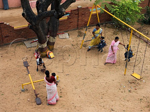 School children playing in the park with their   mothers Chennai Madras India