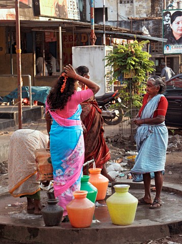Women filling water containers at tap Chennai   Madras India
