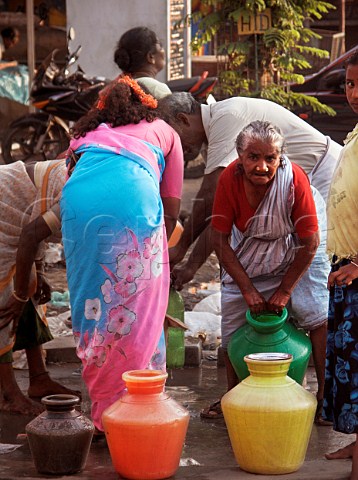 Water containers being filled at tap Chennai   Madras India