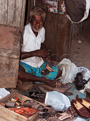 Cobbler at work by roadside Chennai Madras India