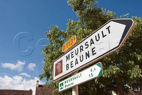 D113 road sign in the centre of PulignyMontrachet   indicating the wine route to Meursault and Beaune    Cte dOr France  Cte de Beaune