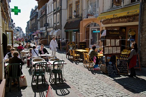 Terrace tables outside the many cafs and   restaurants on Rue de Lille in the old quarter of   Boulogne PasdeCalais France