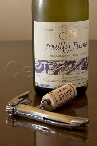 Bottle of Pouilly Fum wine with corkscrew