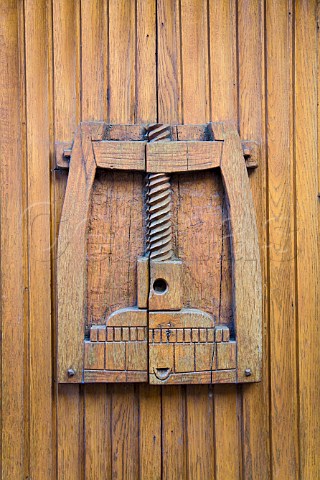 Carving of traditional wine press on wine cellar   doors Gueberschwihr HautRhin France  Alsace