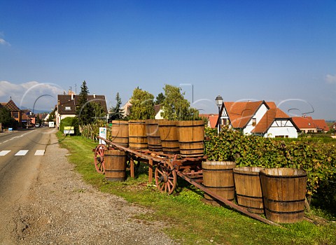Decorative cart and wine tubs at entrance to the   wine village of Bennwihr HautRhin France  Alsace