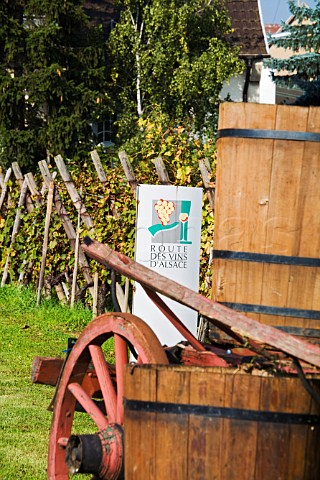Route des Vins dAlsace sign and decorative wine   tubs at entrance to the wine village of Bennwihr   HautRhin France  Alsace