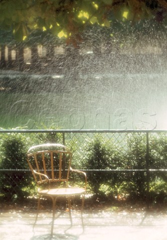 Chair and water sprinkler in Jardin des   Tuileries Paris France