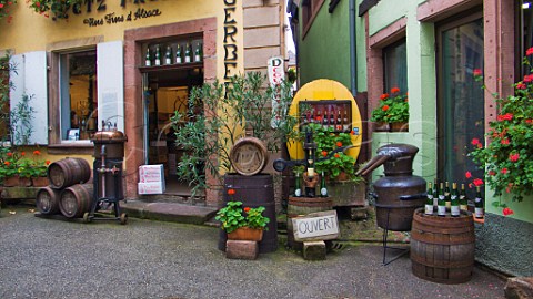 Display of bottles barrels and old stills outside a   wine shop Ribeauvill HautRhin France  Alsace