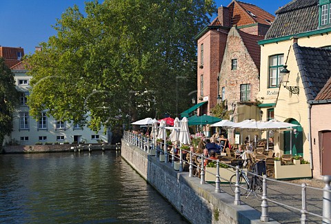 Terrace seating at a canalside restaurant Langestraat Bruges Belgium