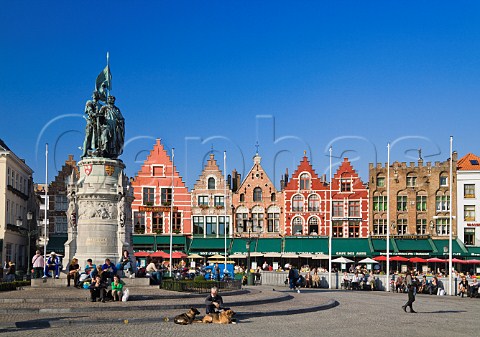 Statue of Jan Breidel and Peter de Coninck and row of restaurants in the Markt the old market square in the centre of Bruges Belgium