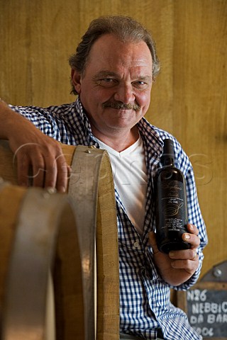 Riccardo Seghesio of Aldo e Riccardo Seghesio with bottle of his La Villa Barolo Monforte dAlba Piemonte Italy