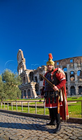 Roman soldier posing for tourists outside the Colosseum Rome Italy