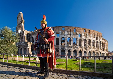 Roman soldier posing for tourists outside the Colosseum Rome Italy