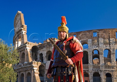 Roman soldier posing for tourists outside the Colosseum Rome Italy