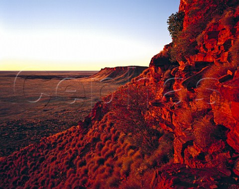 Red sunset light on the western escarpment of the Breadon Hills near Well 48 on the Canning Stock Route Great Sandy Desert Western Australia