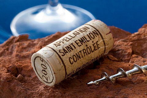 Saintmilion 2005 cork with corkscrew on rustic terracotta surface