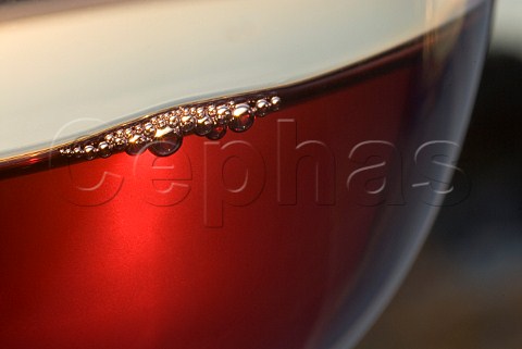 Close view on bubbles forming in a freshly poured glass of red