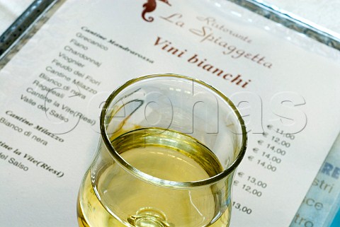 Glass of white wine on Sicilian wine list of the restaurant La Spiaggetta in Fontane Bianche Sicily