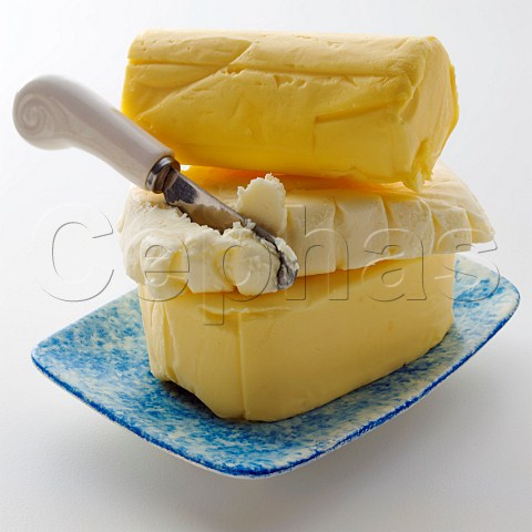 A stack of butter pats with knife