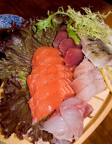 Japanese sashimi displayed on a wooden boat