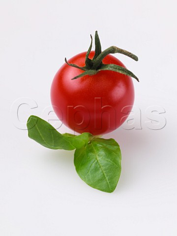 Tomato with basil leaves