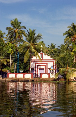 Church amongst the palm trees on the bank of the Kuttanad the backwaters of Kerala known as the Venice of the East Kerala India