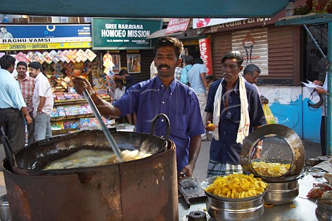 Man making banana chips in a deep fat fryer Thiruvananthapuram Trivandrum Kerala India