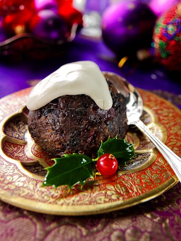 Christmas Individual Christmas pudding with cream and holly