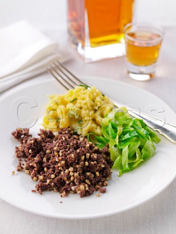Haggis with bashed neeps cabbage and whiskey