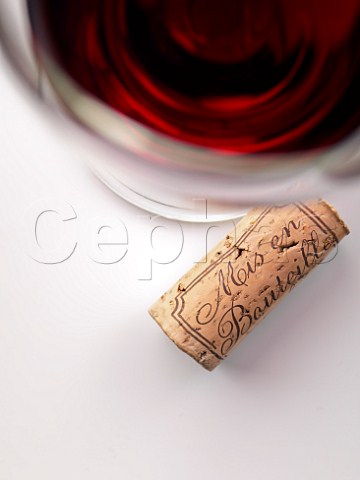 Glass of red wine with cork
