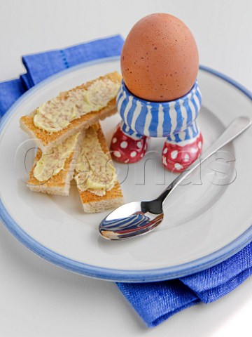 Boiled egg with toast soldiers in childrens egg cup