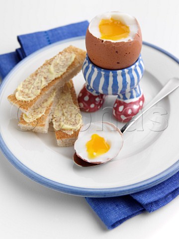 Soft boiled egg with toast soldiers in childrens egg cup