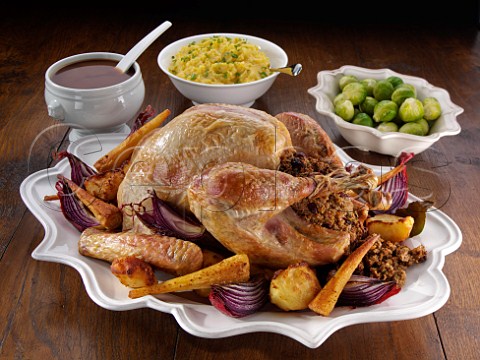 Roast Turkey with stuffing roast vegetables gravy mashed swede and brussel sprouts