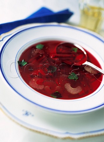 Bowl of beetroot soup in a white table setting