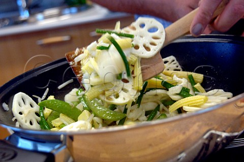 Stir frying vegetables in a wok
