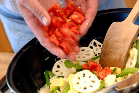Stir frying vegetables in a wok