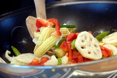 Stir frying vegetables in a wok