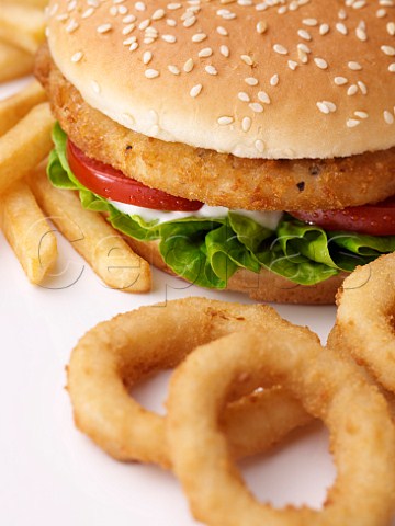 Chicken burger with onion rings and chips