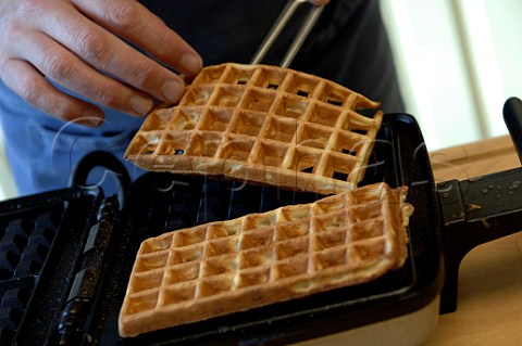 Making waffles lifting them out of the waffle iron