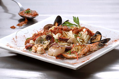 Mixed seafood with tagliatelle on a square plate