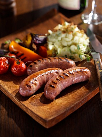Grilled sausages and vegetables with mashed potato