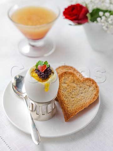 Valentines Day breakfast Boiled egg with caviar and heart shaped toast