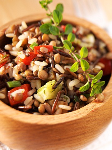 Wild rice and lentil salad with thyme in a wooden bowl