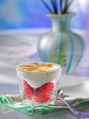Raspberries and strawberries topped with yoghurt and a drizzle of honey