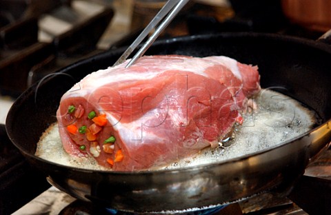 Sealing a joint of pork in a frying pan